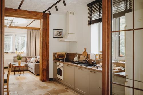 a kitchen and living room with a couch at Pasieka Podlaska Tradycja in Siemiatycze