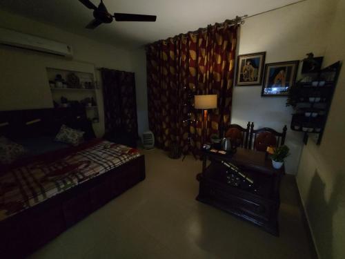 a bedroom with a bed and a couch in a room at Dhairya's Villa Home Away From Home in Jammu