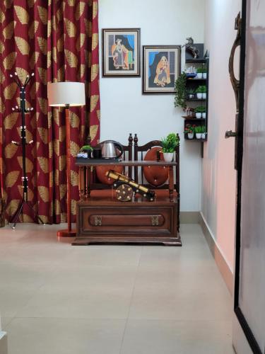 a room with a table and a lamp on a floor at Dhairya's Villa Home Away From Home in Jammu