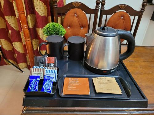 a tray with a tea kettle on top of a table at Dhairya's Villa Home Away From Home in Jammu