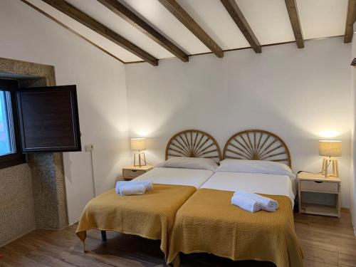 um quarto com 2 camas e uma televisão de ecrã plano em Lugar do Curro, San Martiño de Ozón em Muxia