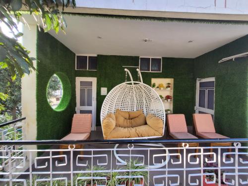 a living room with a couch on a balcony at Dhairya's Villa Home Away From Home in Jammu