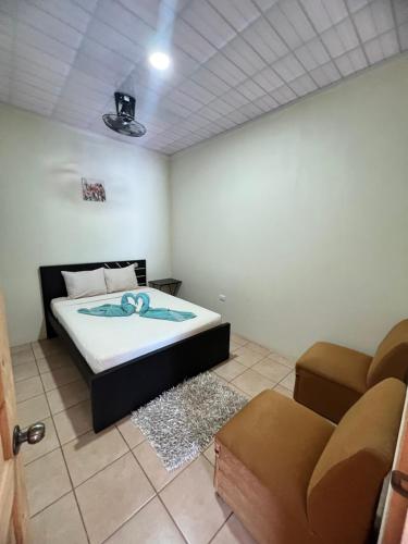 - une chambre avec un lit et un canapé dans l'établissement Los sueños RyG 1, à Quepos