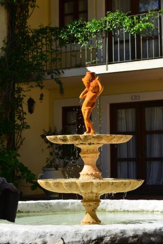 a statue of a teddy bear sitting on top of a fountain at Don Antonio Posada in Colonia del Sacramento