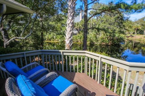 a deck with chairs and a view of a river at Surfscoter in Johns Island