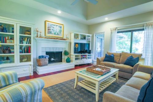 a living room with a couch and a fireplace at Surfscoter in Johns Island