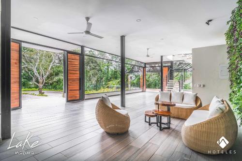 a living room with two chairs and a table at Natura Lake - Casa Campestre in Anapoima