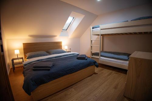 a bedroom with a bed and two bunk beds at Chalupa Martinček in Terchová