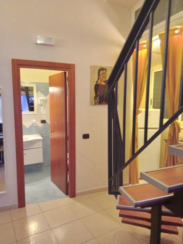 a hallway with a staircase and a door to a bathroom at B&B Maryflower in Naples