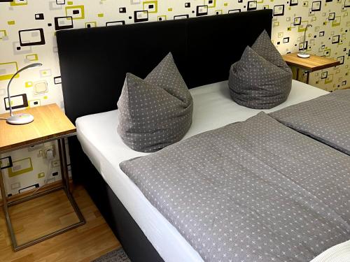 a bedroom with a bed with two pillows on it at Ferienwohnung Bautzen Süd in Bautzen