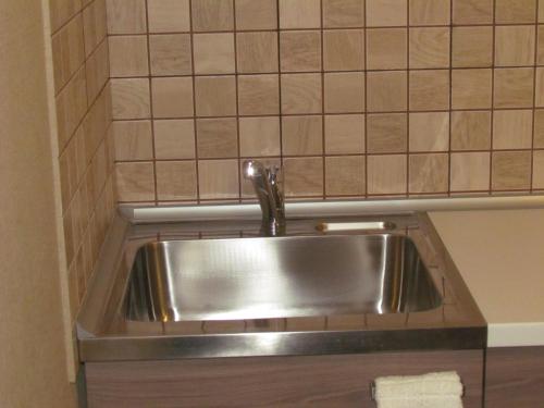 a stainless steel sink in a small kitchen at Апартаменты на Новгородской 4 in Vologda