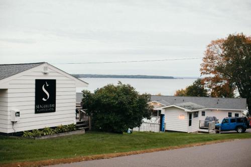 a house with a sign on the side of it at Seagull Bay Motel in Bayfield
