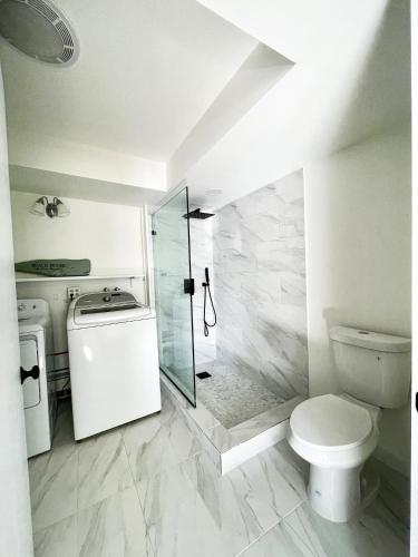 a bathroom with a toilet and a walk in shower at The Montauk Soundview in Montauk