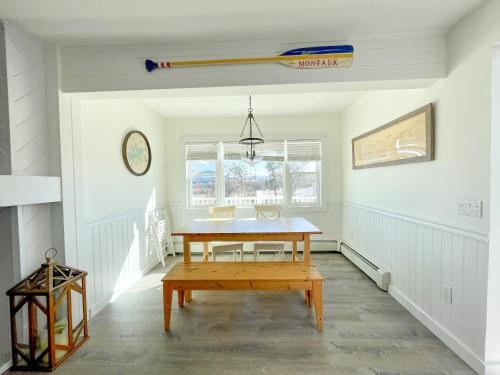 a dining room with a table and a baseball bat on the wall at The Montauk Soundview in Montauk