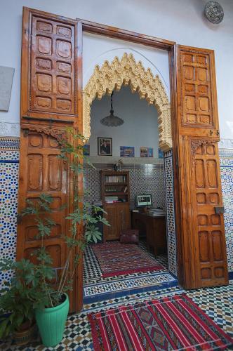 an entrance to a room with a large wooden door at Riad Dar Jabador in Sale