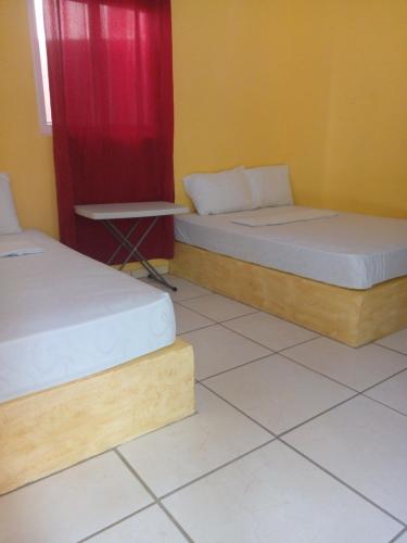 Кровать или кровати в номере Cabañas Martina Surf Playa Guanico