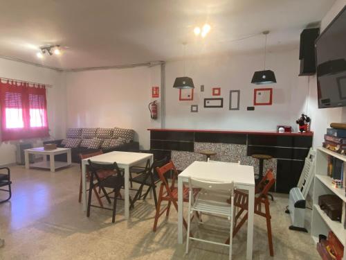 ein Wohnzimmer mit 2 Tischen und einem Kamin in der Unterkunft El Abigero II in La Fregeneda