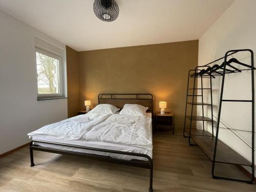 a bedroom with a bunk bed and a ladder at Neubauwohnung im Herzen Panketal in Panketal