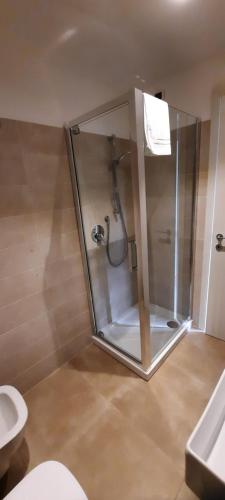 a glass shower in a bathroom with a toilet at Casa di ALTAVILLA in Alba