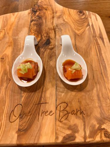 two small dishes of food on a wooden table at Stunning location on Pendle Hill in Nelson