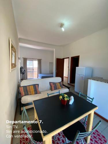 a bedroom with a bed and a table in a room at Sarmiento Monoambiente in Concordia