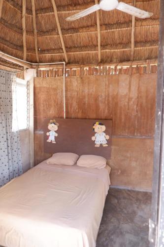 a bedroom with a bed in a hut at Casa Chi in Valladolid