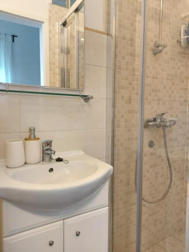 a bathroom with a sink and a shower at Apartment46 in Mali Lošinj