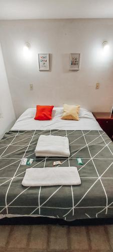 a large bed with three pillows on top of it at Departamento DERQUI en la mejor zona de NVA CBA in Cordoba