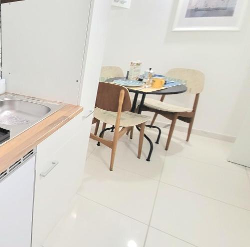 a kitchen with a table and chairs in a room at B & B LuVì in Vibo Valentia