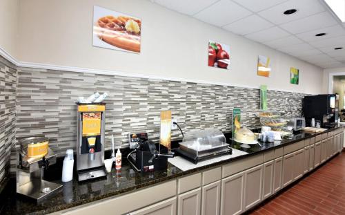 a restaurant kitchen with a counter with food on it at Rodeway Inn Harbison Area in Columbia