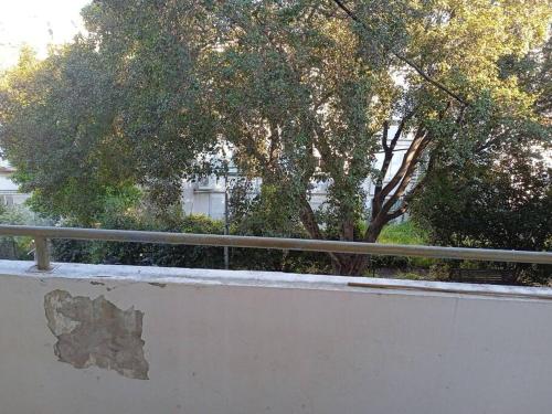 a concrete wall with trees in the background at דירת נופש משמר הגבול 9 דירה 14 in Haifa