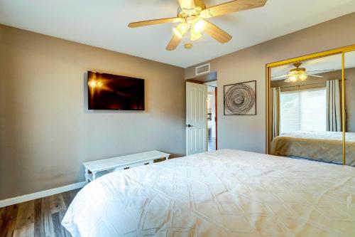 a bedroom with a bed and a ceiling fan at Peoria Vacation Rental with Pool and Hot Tub! in Peoria
