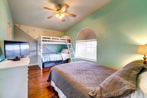 a bedroom with a bunk bed and a ceiling fan at Peoria Vacation Rental with Pool and Hot Tub! in Peoria