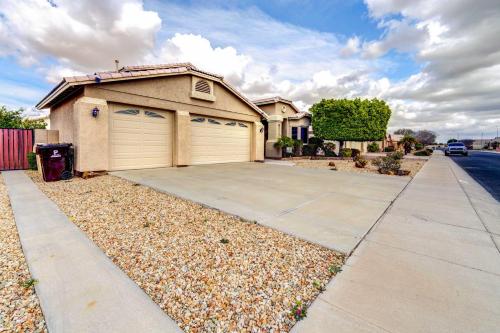 a house with two garage doors and a driveway at Peoria Vacation Rental with Pool and Hot Tub! in Peoria