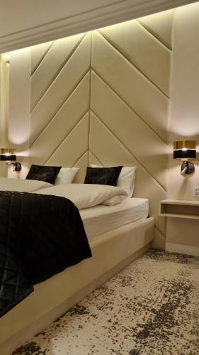 a bedroom with two beds and two lights on the wall at Apartament Bulwary Oświęcim in Oświęcim