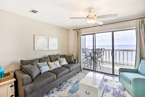 a living room with a couch and a view of the ocean at Waterfront Escape with Balcony on Shell Point Beach! in Panacea