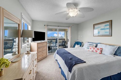 a bedroom with a bed and a television and a balcony at High View in Avon