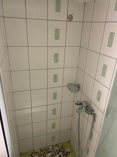 a shower with a hose in a bathroom at Piccolo Centrale in Corfu
