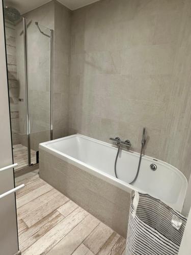 a white bath tub in a bathroom with a shower at Luxurious and cosy loft - Knokke in Knokke-Heist