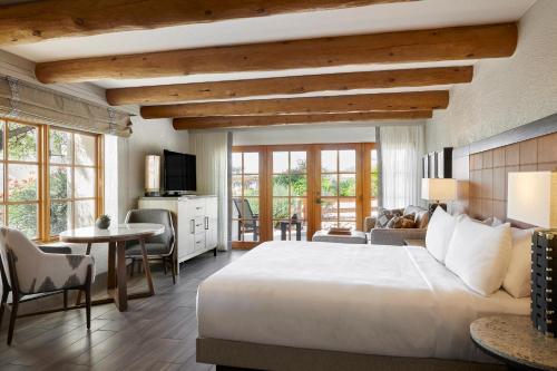 a bedroom with a large bed and a living room at JW Marriott Scottsdale Camelback Inn Resort & Spa in Scottsdale