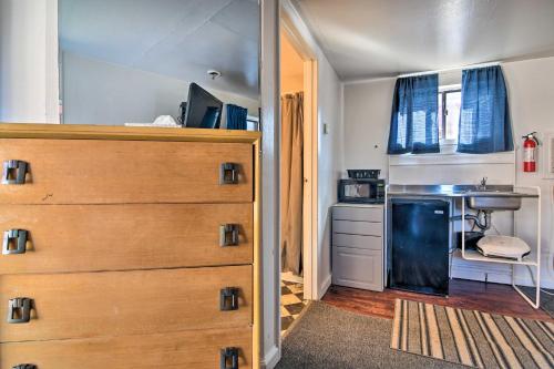 a bedroom with a dresser and a kitchen with a sink at Vacation Rental in Loveland 1 Mi to Downtown! in Loveland