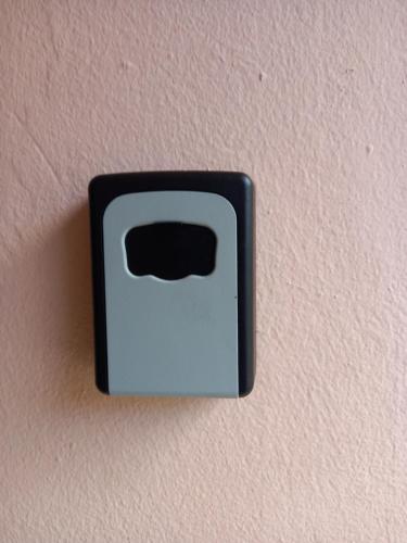 a black electrical outlet on a pink wall at Niky house in Fort-de-France