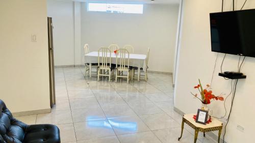 タクナにあるDepartamento Avenida Bolognesi Tacnaのダイニングルーム(テーブル、椅子、テレビ付)