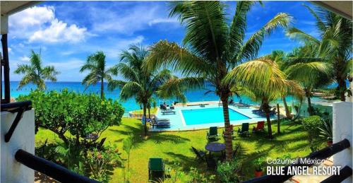 a view of a resort with a swimming pool and the ocean at Blue Angel Resort in Cozumel