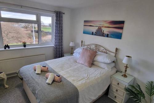 a bedroom with a bed with two stuffed animals on it at Waterfront - Holes Bay, Poole, Dorset in Hamworthy