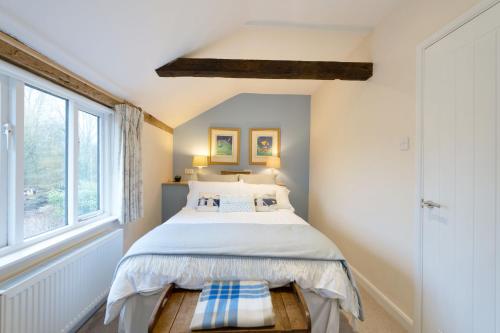 a bedroom with a bed and a window at The Granary, Cretingham in Woodbridge