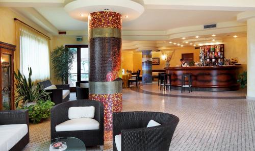 a lobby with a column with colorful tiles on it at Hotel Aktea in Lipari