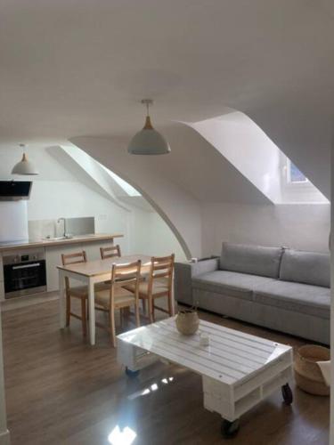 un salon avec un canapé et une table dans l'établissement Au bord de la Mayenne, à Laval