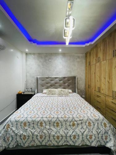 1 dormitorio con 1 cama grande y techo azul en Guayaquil, Ecuador - sur de la ciudad, en Guayaquil
