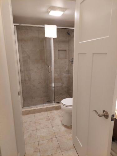 a bathroom with a shower and a toilet in it at The Water Street Inn in Ephraim